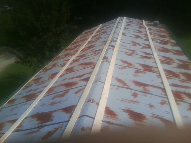 Rusted metal roof panels with new wood purlins before replacement — Storm Damage Roof Repair in Rifton by Roofing Brothers