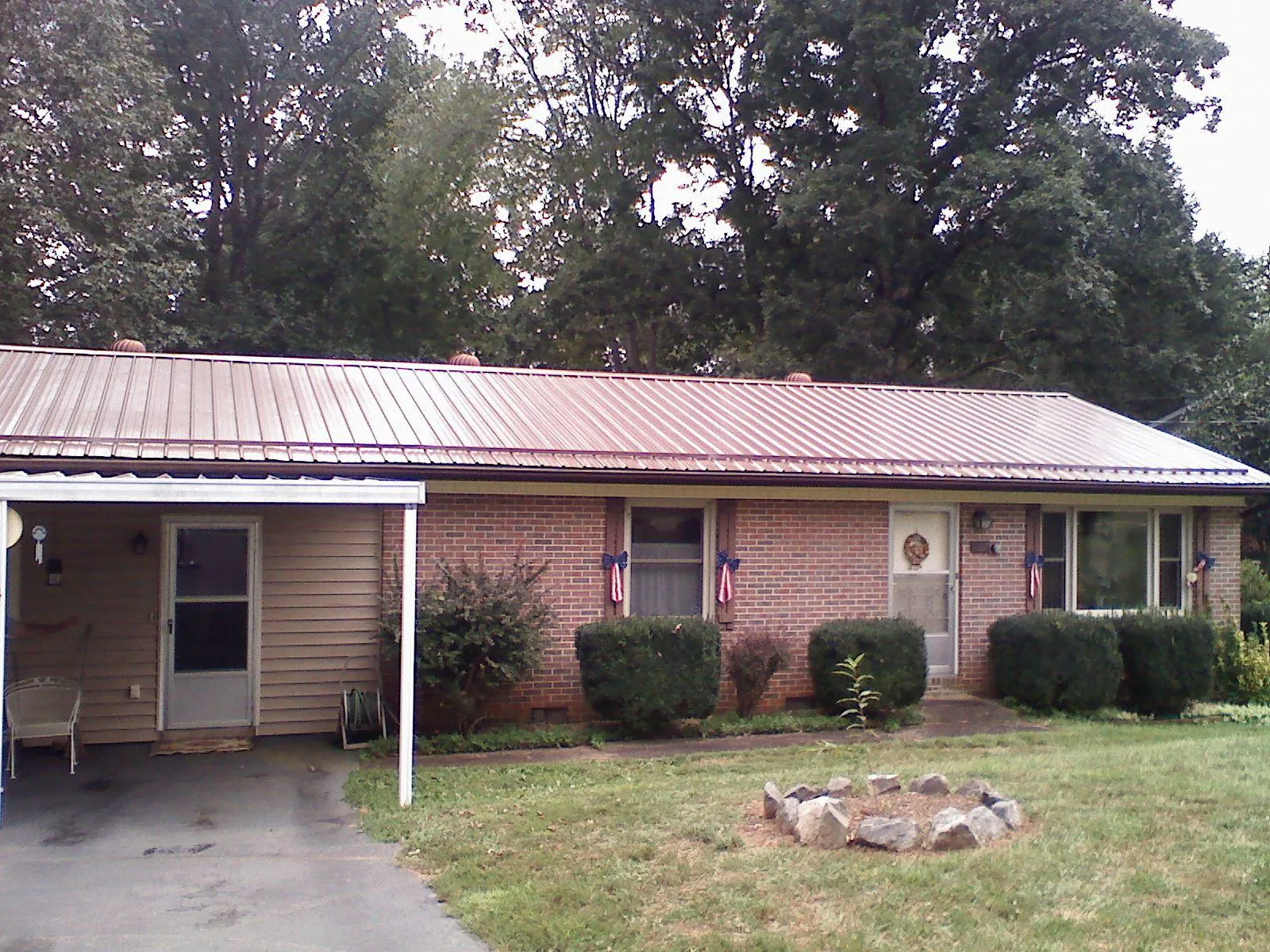 Bronze metal roof and carport on a brick ranch home — Roof Repair work by our crew in Rifton